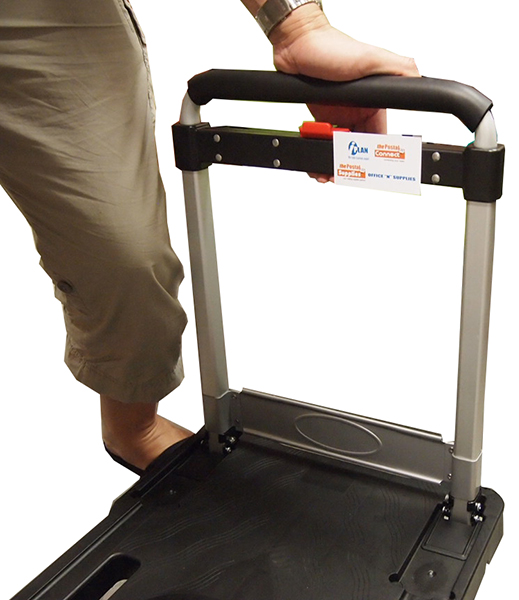 Put the trolley on the flat surface. Push and hold the red button. Extend the handle fully.